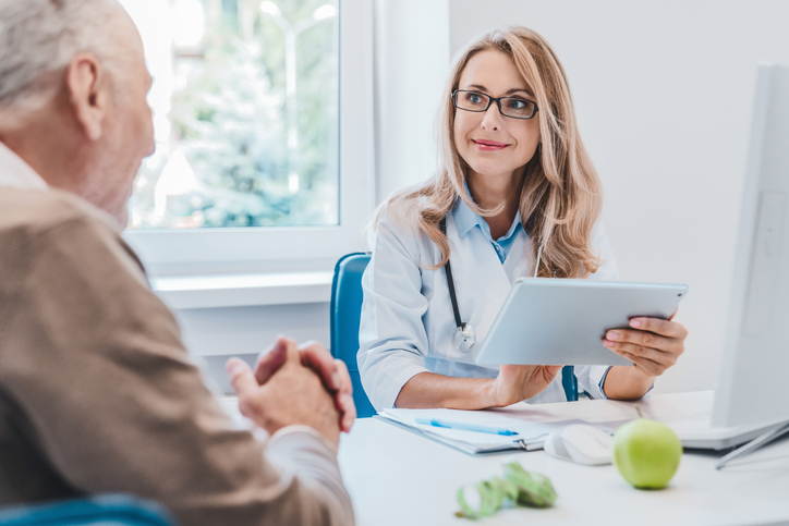 Nutrition Educator speaking to client at her desk