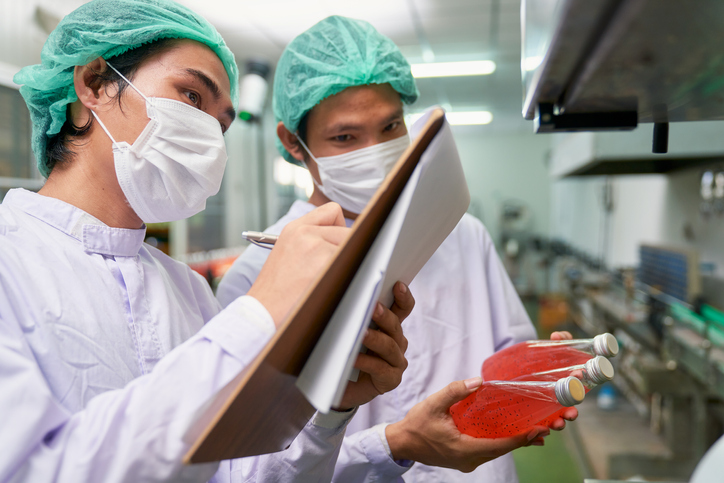 Food Safety Auditors looking over product in a safety lab