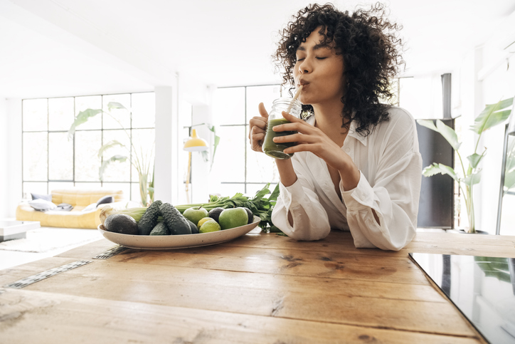 Woman drinking healthy smoothy for energy